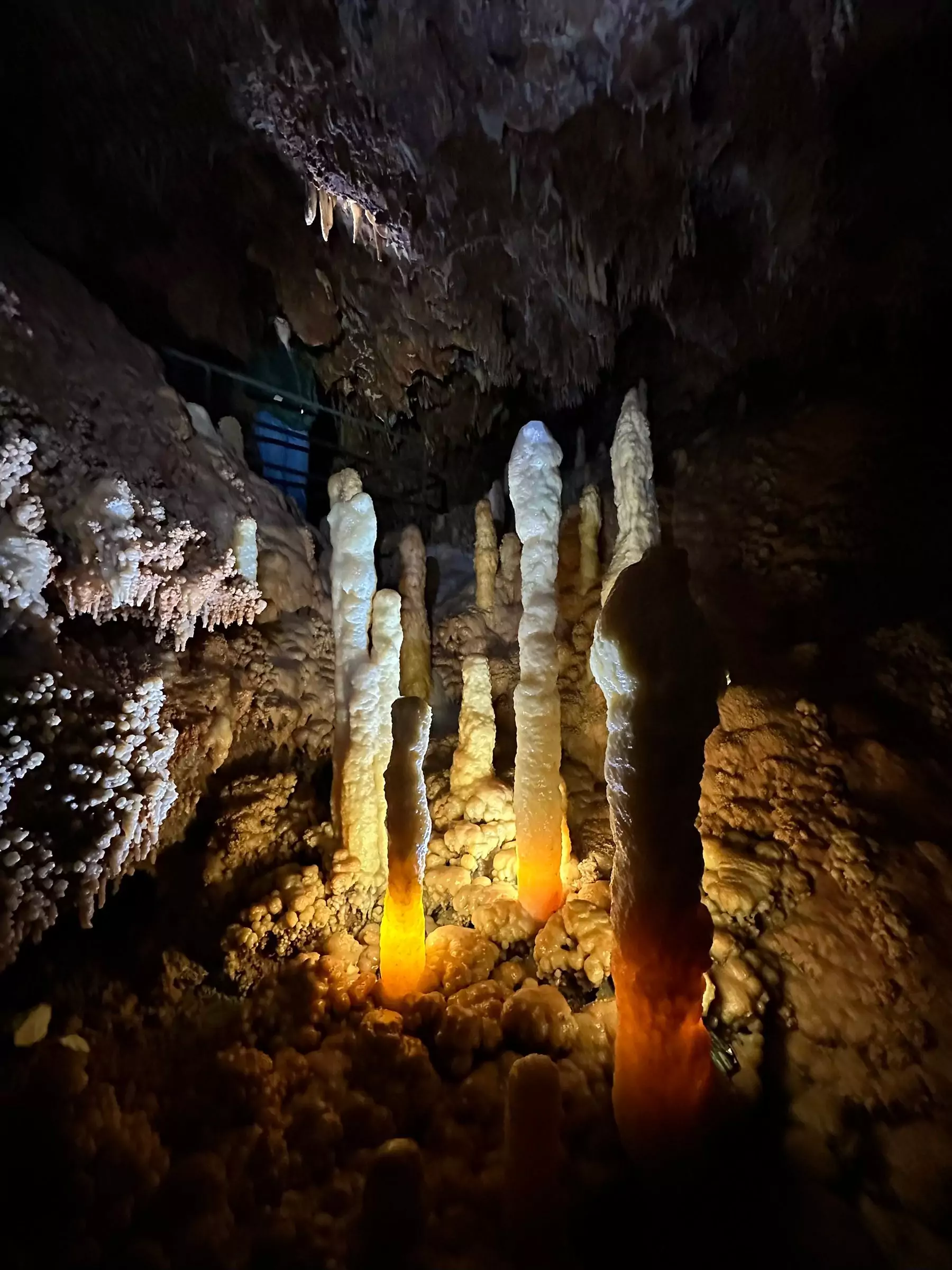 collection of lit stalagmites in the cave